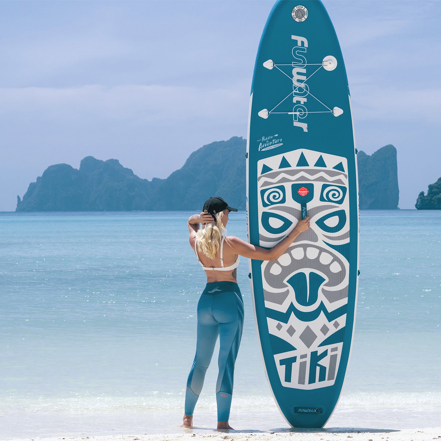 A woman was carrying New Tiki 10'6" Inflatable Paddle Board