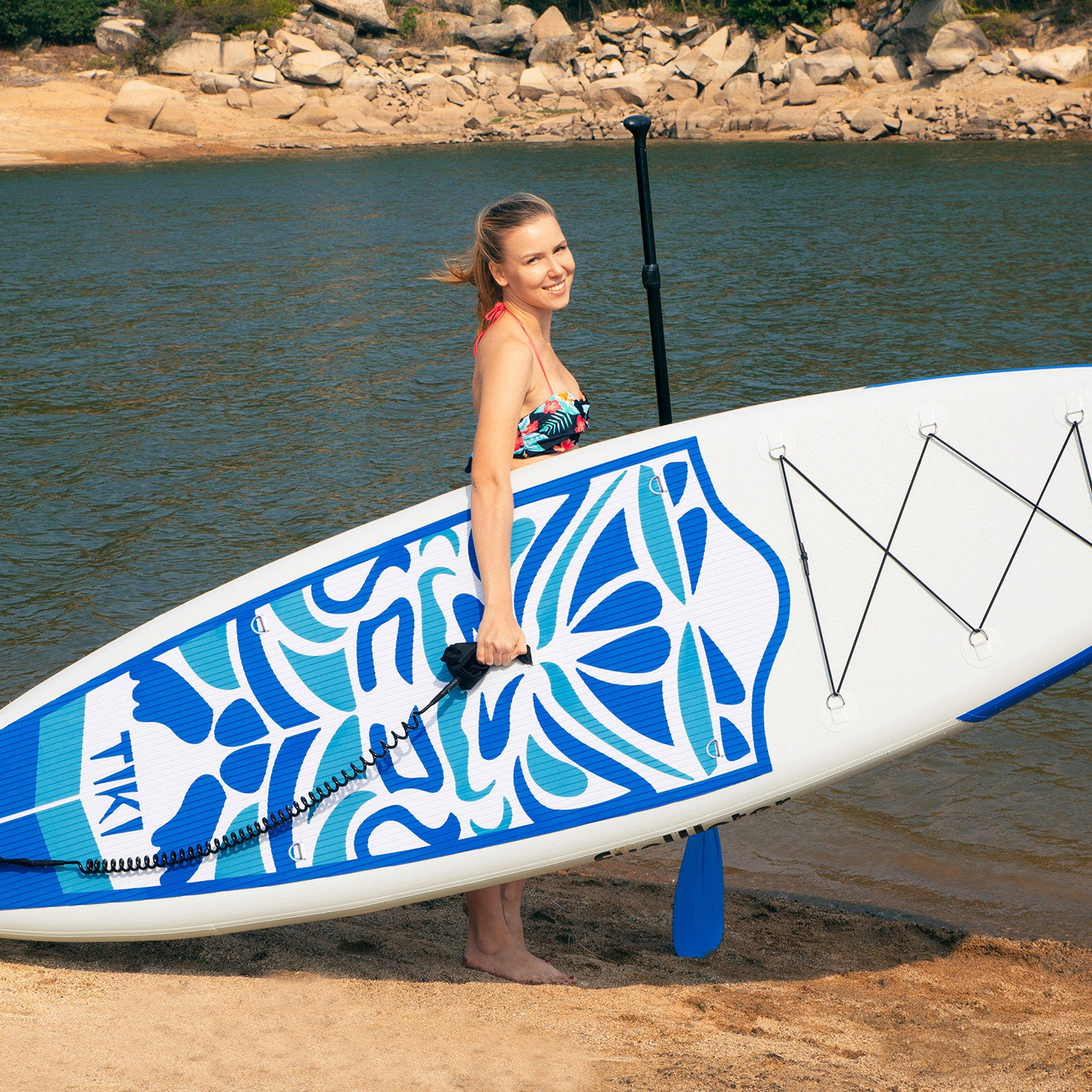 A woman was carrying Tiki inflatable SUP, which is lightweight and easy to carry